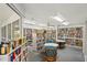 Library with floor to ceiling bookshelves with natural light at 8040 Sailboat Key S Blvd # 304, St Pete Beach, FL 33707