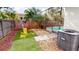 Screened-in pool, small artificial lawn, and wooden fence for privacy in backyard at 814 Tuscanny St, Brandon, FL 33511