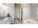 Bright bathroom featuring granite-topped vanity, soaking tub and a closet beyond doorway at 814 Tuscanny St, Brandon, FL 33511