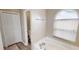 Bright bathroom features a soaking tub beneath an arch window and wood-look tile flooring at 814 Tuscanny St, Brandon, FL 33511