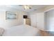 Bedroom with neutral walls, ceiling fan, closet and white door with TV on dresser at 814 Tuscanny St, Brandon, FL 33511