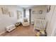 Cozy bedroom featuring neutral walls, plush carpet, rocker, books and toys at 814 Tuscanny St, Brandon, FL 33511