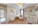 Cozy Bedroom with crib, chair, and natural light creates a serene and inviting space for a baby at 814 Tuscanny St, Brandon, FL 33511