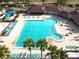 Overhead view of a pristine community pool surrounded by lounge chairs and palm trees at 814 Tuscanny St, Brandon, FL 33511