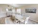 Bright dining room with a large table, decorative mirror, and a tranquil view through the windows at 814 Tuscanny St, Brandon, FL 33511