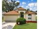 Charming single-story home featuring a well-manicured lawn, lush landscaping, and a cozy two-car garage at 814 Tuscanny St, Brandon, FL 33511