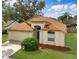 Inviting single-story home boasts a well-kept lawn, mature trees, and a welcoming two-car garage at 814 Tuscanny St, Brandon, FL 33511