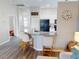 Kitchen island with seating, stone countertops, stainless sink, and white cabinets adjacent to a spacious Gathering room at 814 Tuscanny St, Brandon, FL 33511