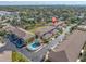 Community aerial view showcasing the pool, landscaping, and townhouse-style home exteriors near a waterway at 868 Date Palm Ln, St Petersburg, FL 33707