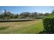 Backyard view showing the green space, landscaping and waterway of the property at 868 Date Palm Ln, St Petersburg, FL 33707