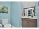 Bathroom with a modern vanity, toilet, and decorative art at 868 Date Palm Ln, St Petersburg, FL 33707