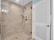 Tiled shower with glass door and multiple shower heads at 868 Date Palm Ln, St Petersburg, FL 33707