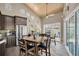 Open dining area featuring light wood flooring, vaulted ceilings, and a modern ceiling fan at 868 Date Palm Ln, St Petersburg, FL 33707