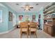 Inviting dining space featuring a spacious wooden table, comfortable chairs, and neutral-toned tile flooring at 868 Date Palm Ln, St Petersburg, FL 33707