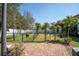 Community dog park with a secure fence, grassy area, and shade trees at 868 Date Palm Ln, St Petersburg, FL 33707