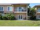 Exterior view of the home featuring a private patio, balcony, and lush landscaping at 868 Date Palm Ln, St Petersburg, FL 33707