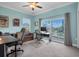 Bright home office featuring functional desks, comfortable seating, and balcony access with scenic views at 868 Date Palm Ln, St Petersburg, FL 33707