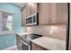 Kitchen features stainless steel appliances, modern cabinetry and tiled backsplash at 868 Date Palm Ln, St Petersburg, FL 33707