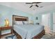 Bedroom featuring a wooden bed frame, ceiling fan, and a nightstand at 868 Date Palm Ln, St Petersburg, FL 33707