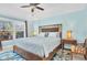 Bedroom featuring a wooden bed frame, ceiling fan, and multiple windows at 868 Date Palm Ln, St Petersburg, FL 33707