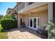 Outdoor patio area with brick flooring, ceiling fan, and doors leading inside at 868 Date Palm Ln, St Petersburg, FL 33707