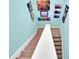 Carpeted staircase with a white handrail and colorful artwork adorning the light-blue walls at 868 Date Palm Ln, St Petersburg, FL 33707