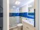 Updated bathroom with a glass shower and blue accents at 8807 Oak Cir, Tampa, FL 33615