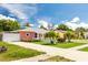 Single-story home with a palm tree-lined yard and driveway at 8807 Oak Cir, Tampa, FL 33615