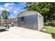 Outdoor metal shed with concrete driveway, perfect for storage and yard equipment at 8807 Oak Cir, Tampa, FL 33615