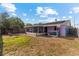 A wide view of the backyard features a partially screened patio, and minimal landscaping at 8903 Bay Bridge Ct, Tampa, FL 33634