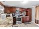 Modern kitchen featuring granite countertops, stainless steel appliances, and ample cabinet space at 8903 Bay Bridge Ct, Tampa, FL 33634