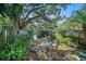 Private backyard oasis with lush landscaping and seating area at 949 Hamilton Ct, Palm Harbor, FL 34683