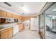 Kitchen with white appliances and wood cabinets at 949 Hamilton Ct, Palm Harbor, FL 34683