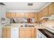 Kitchen with wood cabinets, double sink, and views to living room at 949 Hamilton Ct, Palm Harbor, FL 34683