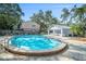 Community pool with spacious deck and covered seating area at 949 Hamilton Ct, Palm Harbor, FL 34683