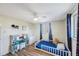 Bright bedroom with a ceiling fan, blue accents, and a comfortable bed at 10201 127Th Pl, Largo, FL 33773