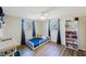 Charming bedroom featuring wood floors, a ceiling fan, and a delightful bookshelf at 10201 127Th Pl, Largo, FL 33773