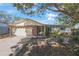 Charming single-story home featuring a two-car garage and stone accents at 10201 127Th Pl, Largo, FL 33773