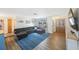 Inviting living room with wood floors, a comfortable sofa, and large windows at 10201 127Th Pl, Largo, FL 33773