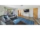 Spacious living room featuring hardwood floors, a large window, and a comfortable sectional sofa at 10201 127Th Pl, Largo, FL 33773