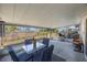 Covered patio featuring a table, chairs, and outdoor access to the backyard at 10201 127Th Pl, Largo, FL 33773