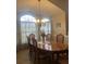 Spacious dining area with a large table, chandelier, and arched windows at 11425 Billingham Blvd, Spring Hill, FL 34609