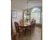 Formal dining room with wood table, chairs, and large windows at 11425 Billingham Blvd, Spring Hill, FL 34609