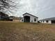View of the back of the house and surrounding yard at 11425 Billingham Blvd, Spring Hill, FL 34609