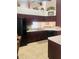 Kitchen with dark wood cabinets, island, and breakfast bar at 11425 Billingham Blvd, Spring Hill, FL 34609