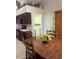 Kitchen with dark wood cabinets, breakfast nook, and laundry access at 11425 Billingham Blvd, Spring Hill, FL 34609