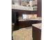 Kitchen with dark wood cabinets, island, and breakfast bar at 11425 Billingham Blvd, Spring Hill, FL 34609