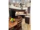 Kitchen with dark wood cabinets, a breakfast bar, and a dining area at 11425 Billingham Blvd, Spring Hill, FL 34609