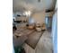 Bright living room with tiled floors, ample seating, and an open floor plan at 11425 Billingham Blvd, Spring Hill, FL 34609