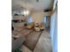 Open living room with tile flooring, comfortable seating and access to other rooms at 11425 Billingham Blvd, Spring Hill, FL 34609